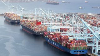 Shipping containers are unloaded from ships at a container terminal at the Port of Long Beach-Port of Los Angeles complex, amid the coronavirus disease (COVID-19) pandemic, in Los Angeles, California, April 7, 2021.