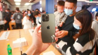 Customers look at the iPhone13 smartphones at apple’s flagship store in Shanghai, China.