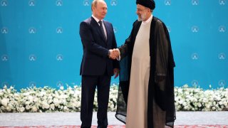 Iranian President Ebrahim Raisi greets Russian President Vladimir Putin on July 19, 2022. Putin likely wanted to show that Moscow is still important in the Middle East by visiting Iran, said John Drennan of the U.S. Institute of Peace.