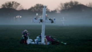 An early morning fog rises where 17 memorial crosses were placed for the 17 students and faculty killed in the shooting at Marjory Stoneman Douglas High School in Parkland, Fla.