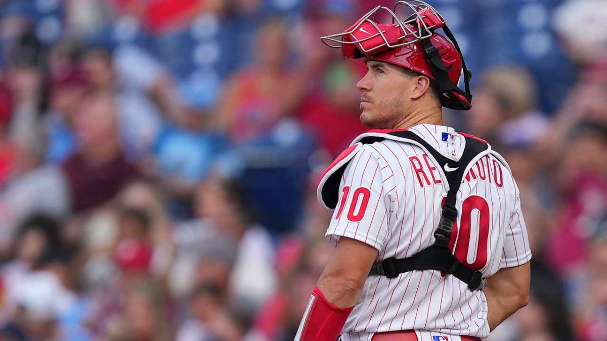 Philadelphia Phillies - Photo of J.T. Realmuto on the field with three 2022  season awards in front of him. From left to right, Realmuto received the  Silver Slugger award, All-MLB First Team