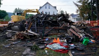 A house that was destroyed by a fatal fire is viewed in Nescopeck, Pa., Friday, Aug. 5, 2022. Multiple people are feared dead after the fire early Friday in northeastern Pennsylvania, according to a volunteer firefighter who responded and said the victims were his relatives.