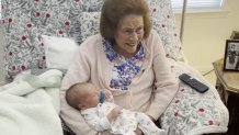 Marguerite Koller holds her 100th great-grandchild, Koller William