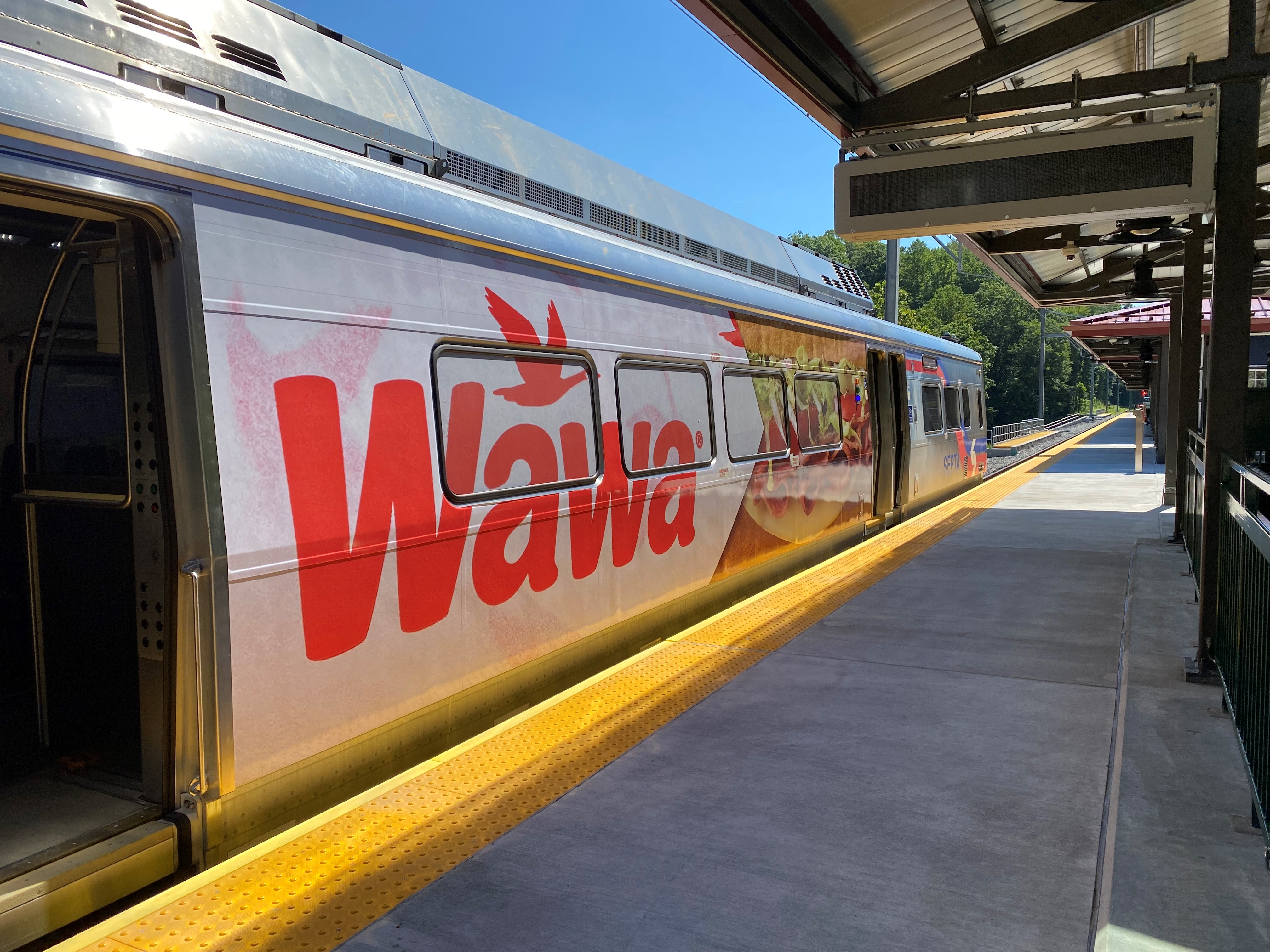 A SEPTA train wrapped in Wawa advertising