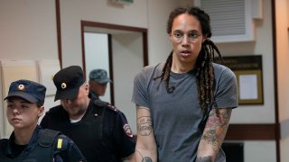 WNBA star and two-time Olympic gold medalist Brittney Griner is escorted from a court room ater a hearing, in Khimki just outside Moscow, Russia, Thursday, Aug. 4, 2022.