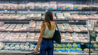A woman shops for chicken at a supermarket in Santa Monica, California, on September 13, 2022.