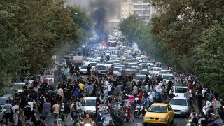In this Sept. 21, 2022, photo taken by an individual not employed by the Associated Press and obtained by the AP outside Iran, protesters chant slogans during a protest over the death of a woman who was detained by the morality police, in downtown Tehran, Iran.