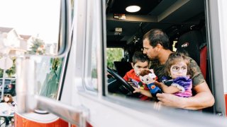 Alexandros Hurdakis, 5, has terminal cancer, so his neighbors threw him an early Halloween celebration on Sept. 14, 2022. He’s pictured here with his father, Nick, and his 2-year-old sister, Eirene.