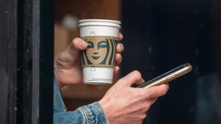 A customer holds a drink inside a Starbucks coffee shop in San Francisco, California, on Thursday, July 28, 2022.