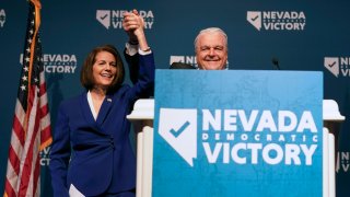 Sen. Catherine Cortez Masto, D-Nev., left, reacts alongside Nevada Gov. Steve Sisolak during an election night party hosted by the Nevada Democratic Party, Tuesday, Nov. 8, 2022, in Las Vegas.