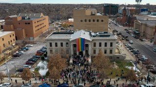 In this aerial image taken with a drone, a rainbow flag is unfurled at City Hall Wednesday, Nov. 23, 2022