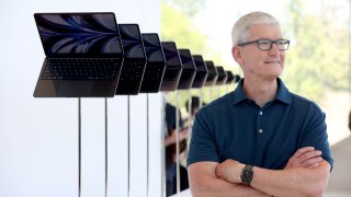 CUPERTINO, CALIFORNIA – JUNE 06: Apple CEO Tim Cook looks at a display of brand new redesigned MacBook Air laptop during the WWDC22 at Apple Park on June 06, 2022 in Cupertino, California. Apple CEO Tim Cook kicked off the annual WWDC22 developer conference. (Photo by Justin Sullivan/Getty Images)