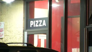 Pizza sign above door