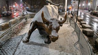 The bull of Wall Street is seen during the pass of the snowstorm on January 31, 2021 in New York City.