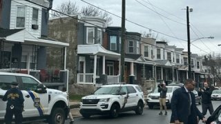 Philly police investigators outside homes