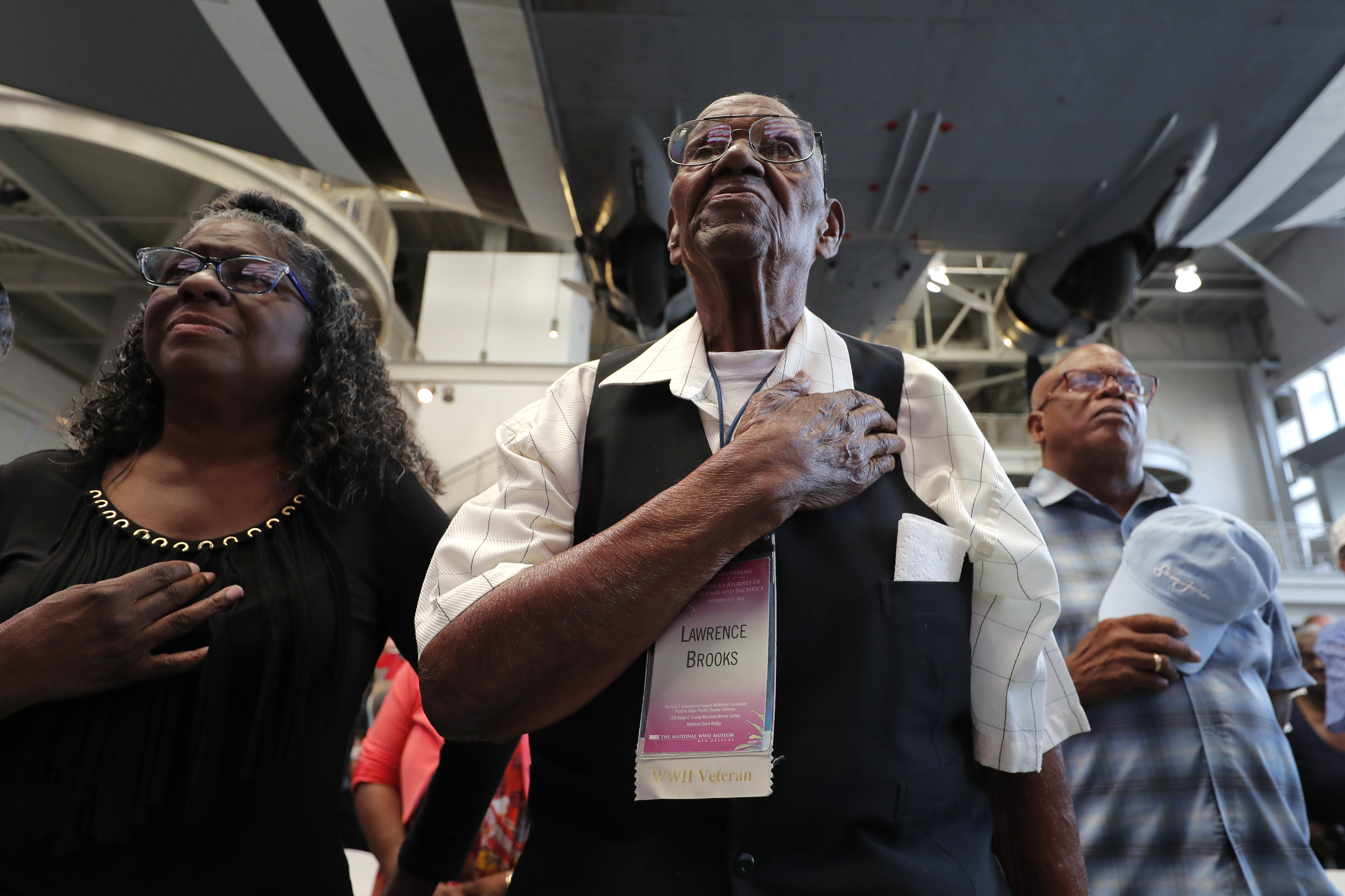 World War II veteran Lawrence Brooks holds his hand to his heart during the singing of the National Anthem as he celebrates his 110th birthday at the National World War II Museum in New Orleans, Thursday, Sept. 12, 2019. Brooks was born Sept. 12, 1909, and served in the predominantly African-American 91st Engineer Battalion, which was stationed in New Guinea and then the Philippines during World War II. He was a servant to three white officers in his battalion. (AP Photo/Gerald Herbert)