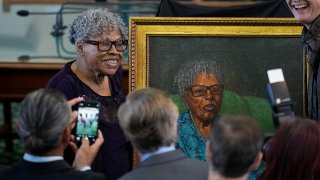 Opal Lee, left, who helped make Juneteenth a federally recognized holiday, poses with her portrait after it was unveiled in the Texas Senate Chamber, Wednesday, Feb. 8, 2023, in Austin, Texas.