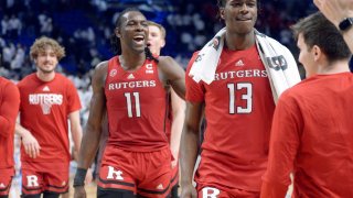 Rutgers' Clifford Omoruyi (11) and Antwone Woolfolk (13) come off the court after defeating Penn State in an NCAA college basketball game, Sunday, Feb. 26, 2023, in State College, Pennsylvania.