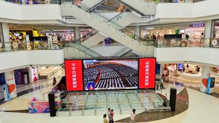 A shopping mall in Qingzhou, Shandong province, broadcasts the opening ceremony of China’s National People’s Congress on Sunday, March 5, 2023.