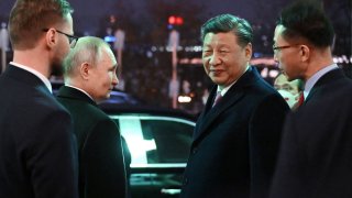 Russian President Vladimir Putin and Chinese President Xi Jinping leave after a reception in honor of the Chinese leader’s visit to Moscow, at the Kremlin in Moscow, Russia March 21, 2023.