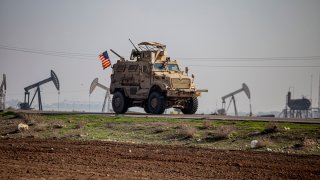 FILE – A US military vehicle on a patrol in the countryside near the town of Qamishli, Syria, Sunday, Dec. 4, 2022.