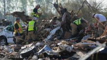 Emergency rescuers and first responders climb through a tornado demolished mobile home park looking for bodies that might be buried in the piles of debris, insulation, and home furnishings, Saturday morning, March 25, 2023, in Rolling Fork, Miss. Emergency officials in Mississippi say several people have been killed by tornadoes that tore through the state on Friday night, destroying buildings and knocking out power as severe weather produced hail the size of golf balls moved through several southern states. (AP Photo/Rogelio V. Solis)