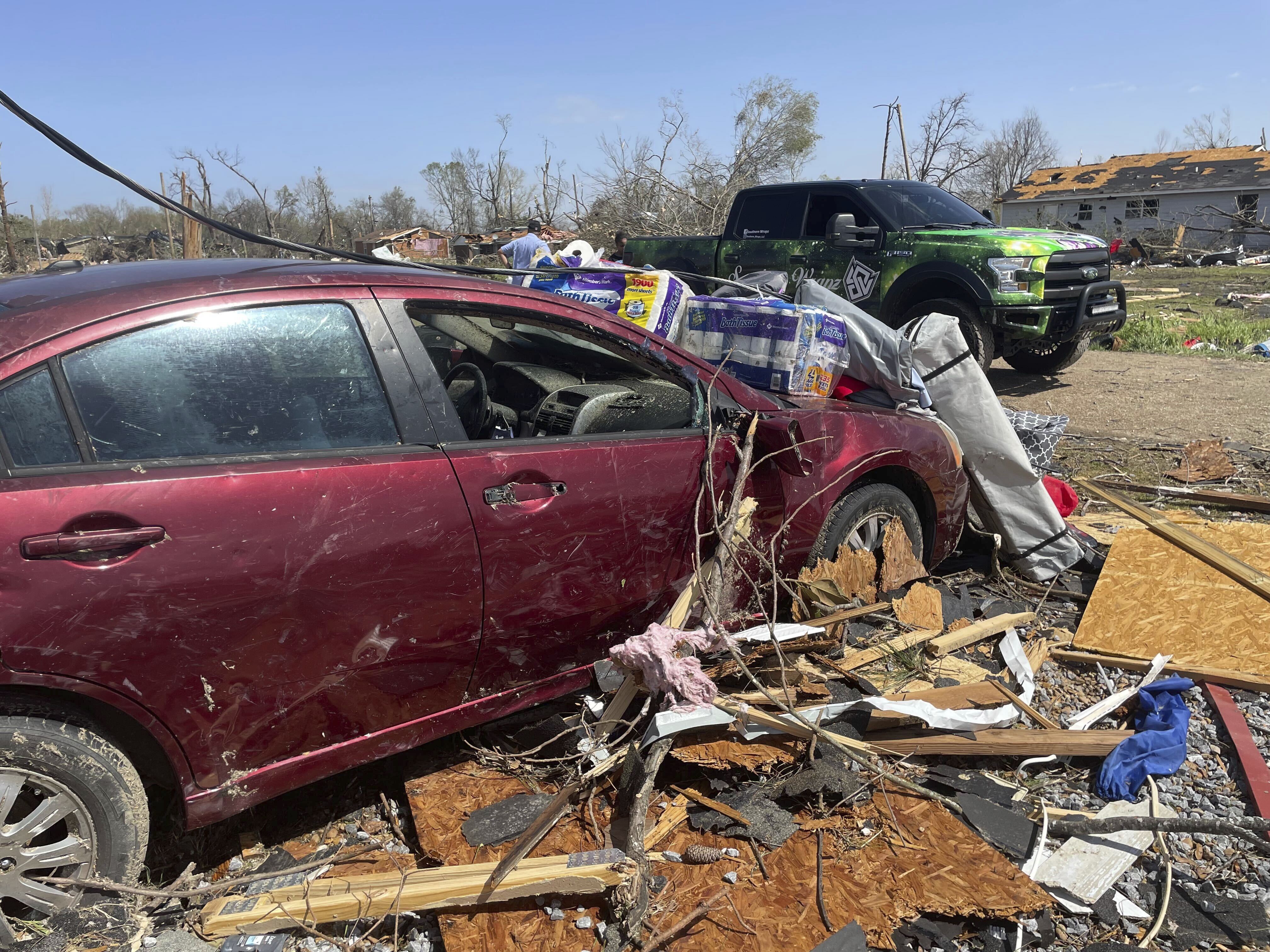 Debris covers the ground on Saturday, March 25, 2023 in Silver City, Miss.  Emergency officials in Mississippi say several people have been killed by tornadoes that tore through the state on Friday night, destroying buildings and knocking out power as severe weather produced hail the size of golf balls moved through several southern states.  (AP Photo/Michael Goldberg)