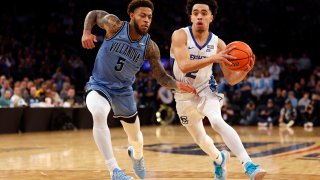 Ryan Nembhard #2 of the Creighton Bluejays dribbles against Justin Moore #5 of the Villanova Wildcats