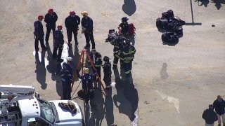 First responders work to rescue a construction worker trapped in a sewer in Mount Laurel, New Jersey on Friday morning.
