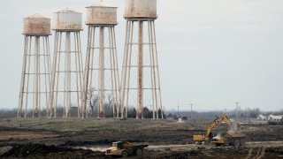 Workers toil at a battery plant in Kansas.