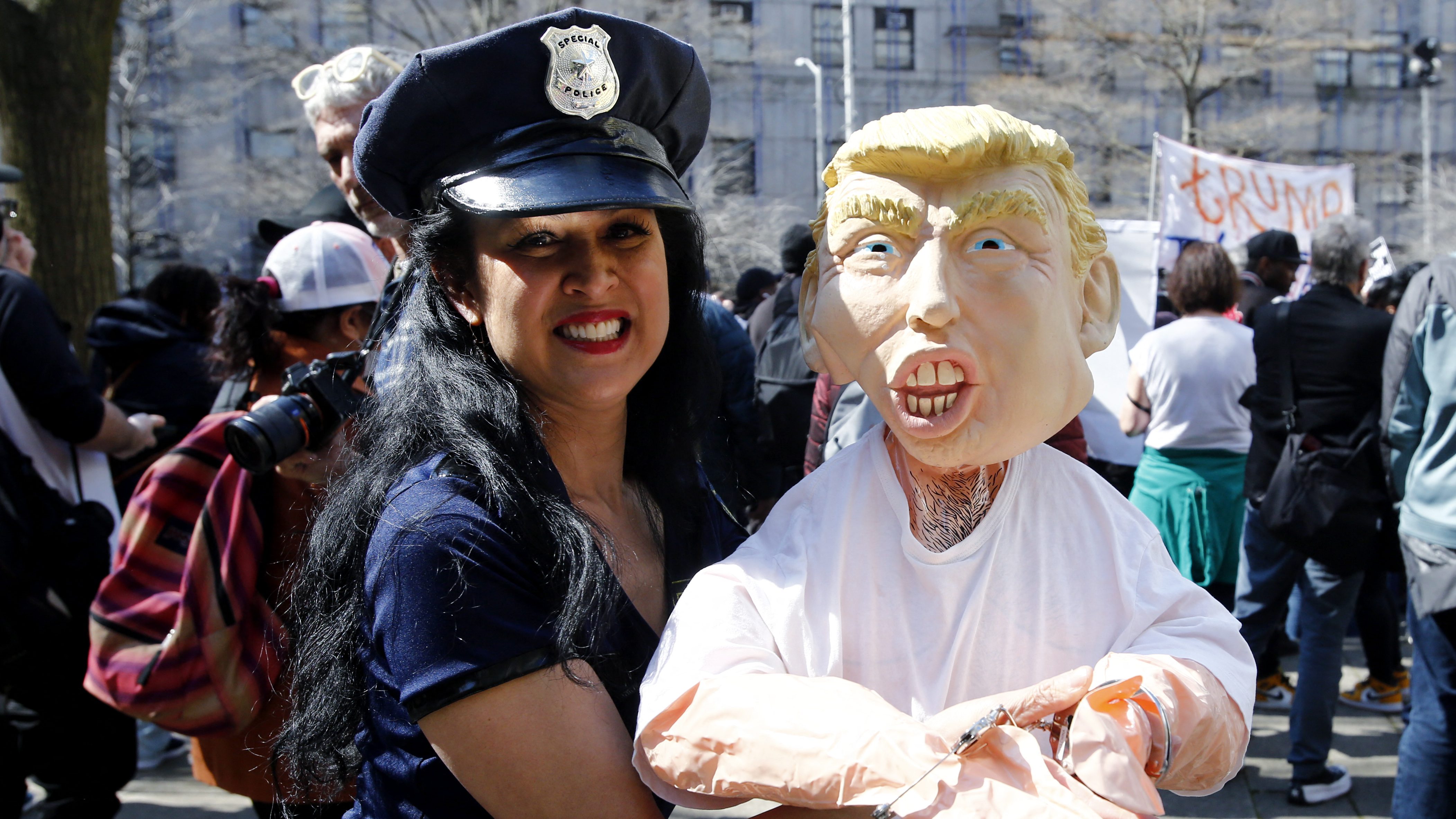 An opponent of former US president Donald Trump protests outside the Manhattan District Attorney’s office.