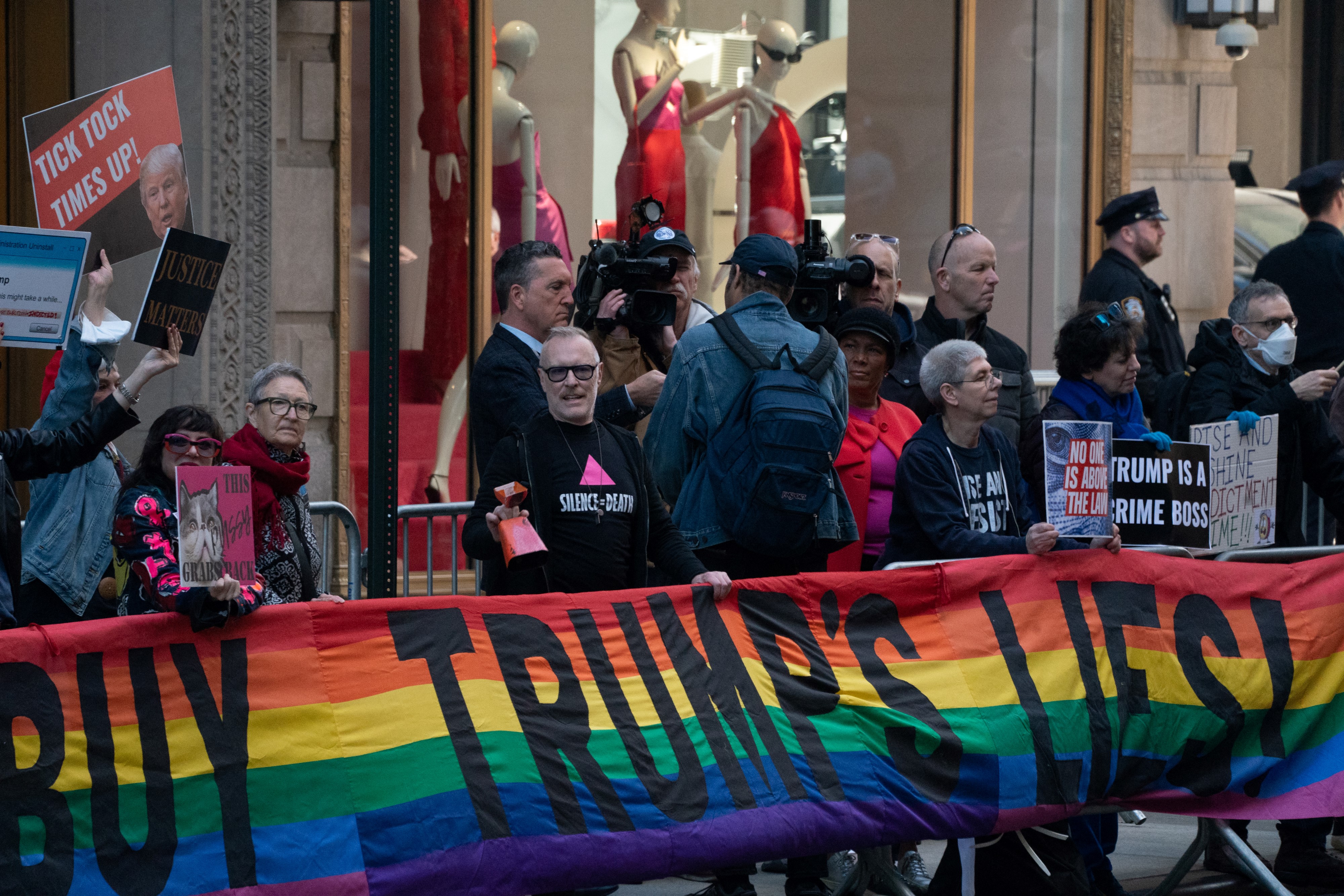 Anti-Trump protesters stand along Fifth Avenue before former US President Donald Trump leaves from Trump Tower for his arraignment in lower Manhattan on April 4, 2023, in New York.