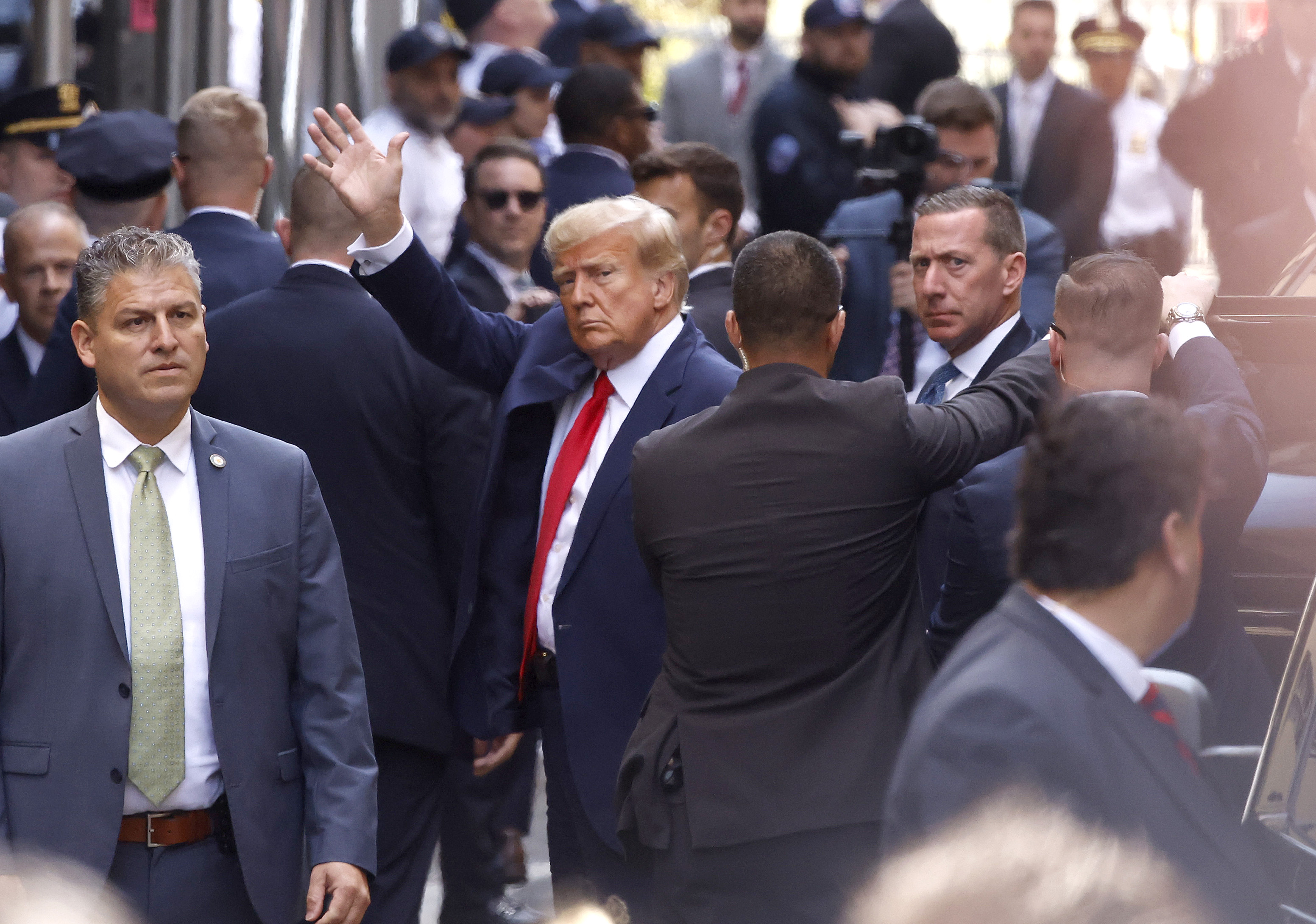 Former U.S. President Donald Trump waves as he arrives at the Manhattan Criminal Court on April 4, 2023, for his arraignment in New York, New York.