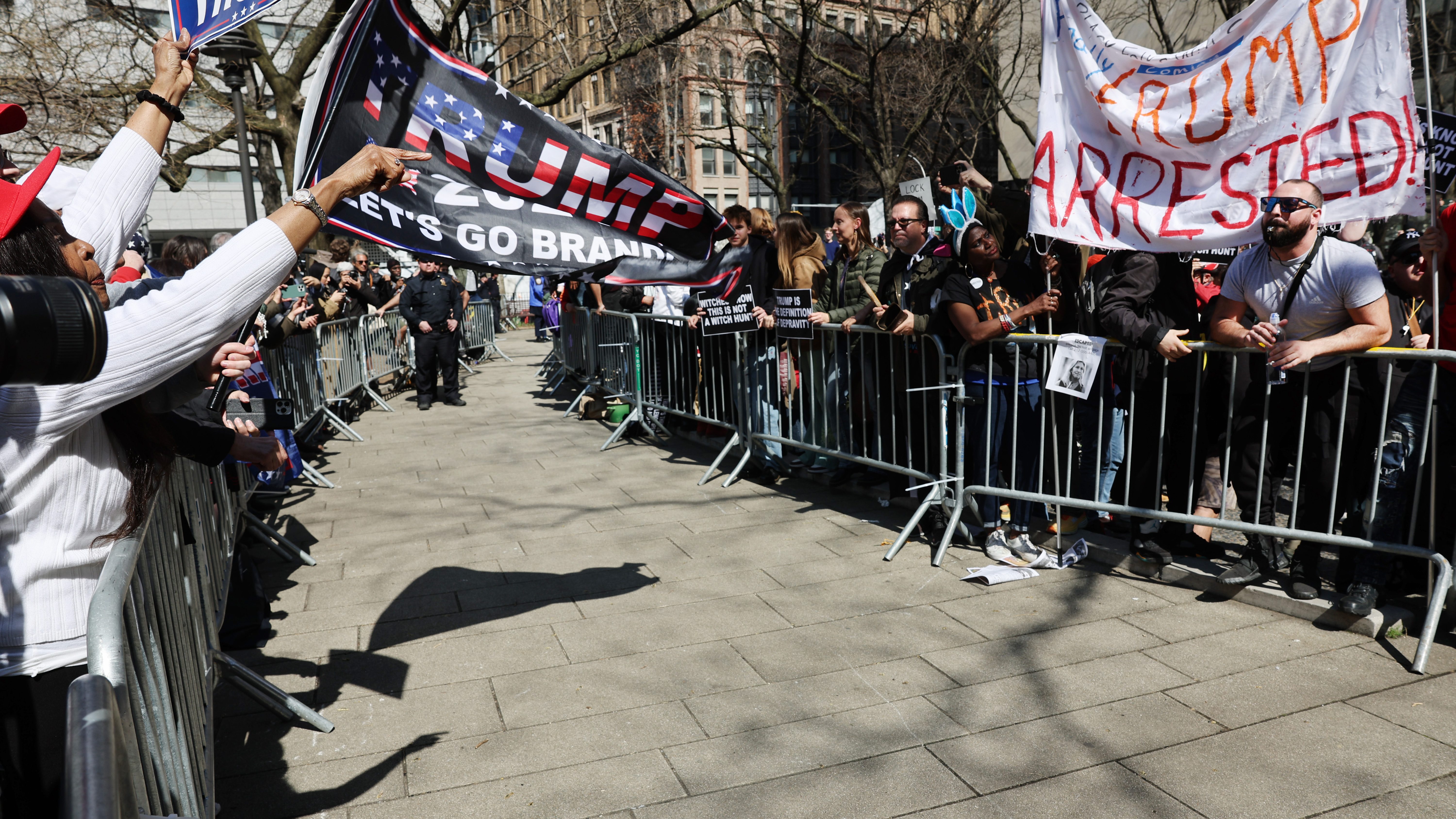 Crowds separated by barriers outside the courthouse in lower Manhattan.