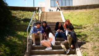 Upper Darby High School students Rayan Hansali, from left, Tanveer Kaur, Elise Olmstead, Fatima Afrani, Joey Ngo and Ata Ollah, talk in the campus courtyard, Wednesday, April 12, 2023, in Drexel Hill.