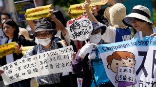 Protesters gather for a rally outside Tokyo Electric Power Company Holdings (TEPCO) headquarters building May 16, 2023, in Tokyo.