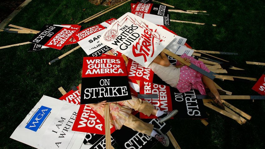 LOS ANGELES, CA – NOVEMBER 09:  Four-year-old Beau Staun-List and eight-year-old Soleil Staun-Snyder (R), whose father Steven List is a striking writer, play in a pile of strike signs as more than 3,000 movie and television writers and their supporters rally outside Fox Studios on the fifth day of their strike against the producers and studios that use them on November 9, 2007 in Century City, California. Television shows are increasingly being force to show re-runs as 12,000-member Writers Guild of America (WGA) strike for a greater share of new media revenue.  (Photo by David McNew/Getty Images)