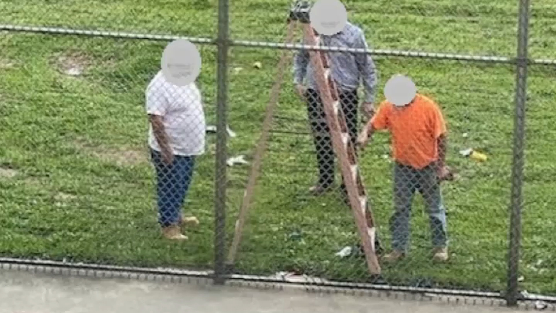 Workers repair a fence at the Philadelphia Industrial Correction Center after two men escaped from the facility. 