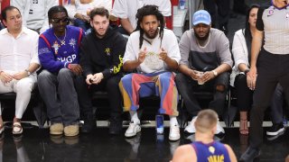 J. Cole looks on during the game between the Denver Nuggets and the Miami Heat during Game Three of the 2023 NBA Finals on June 7, 2023 at Kaseya Center in Miami.