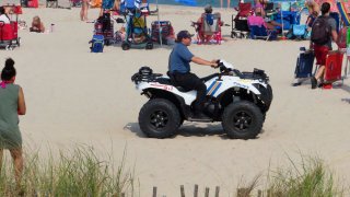 Police officer in ATV on sand