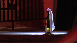 An unexploded Molotov cocktail sits on the porch of a home after an arson attempt in West Philadelphia early Sunday.