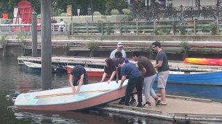Local students launch a handmade boat into the Delaware River on Saturday.