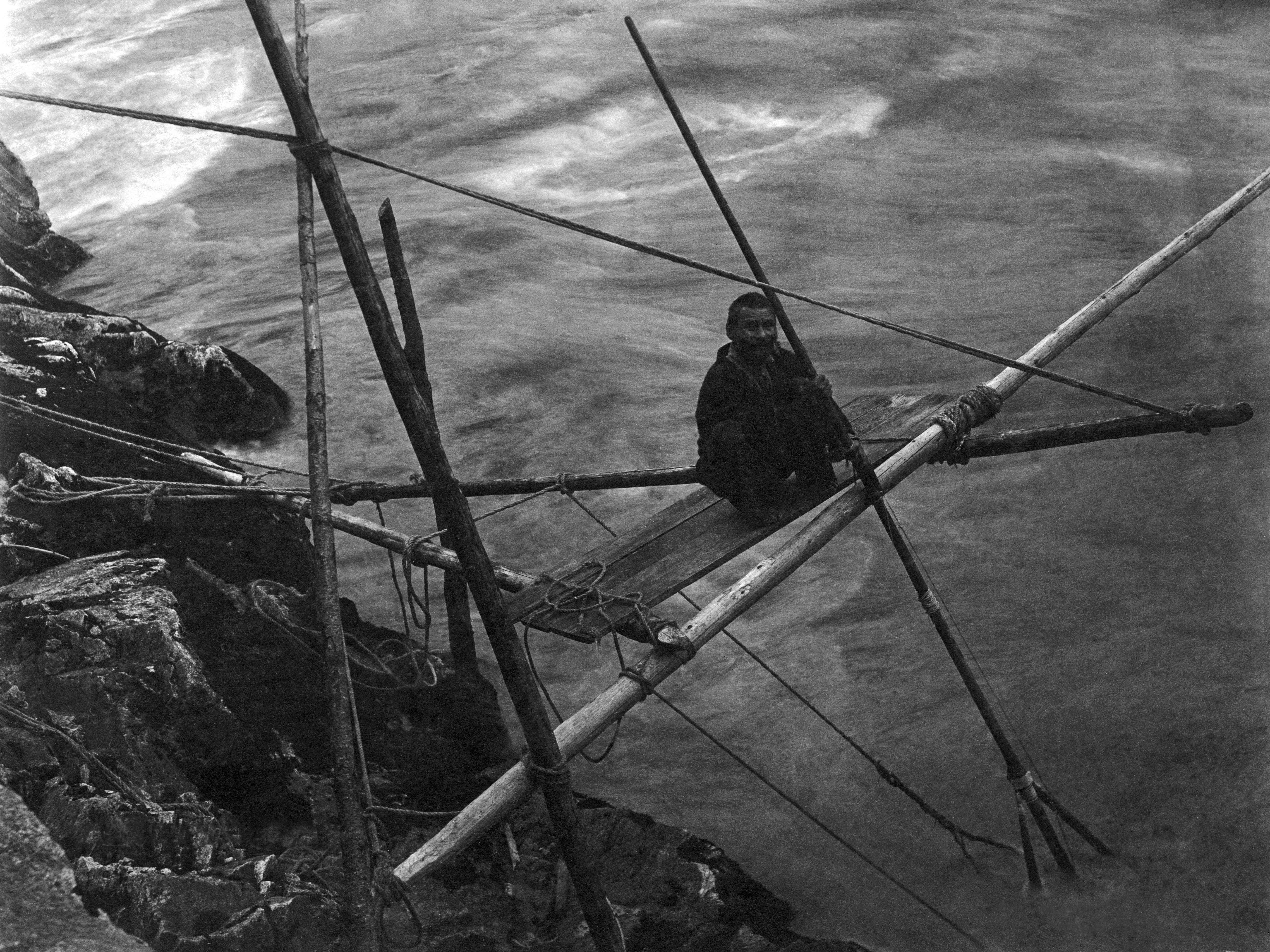 A Kamloop Native American man fishing for salmon on the Fraser River, Kamloops, British Columbia, Canada, late 1890s or early 1900s. (Photo by Edward Thomas/Underwood Archives/Getty Images)