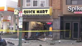 Smashed storefront behind yellow police tape