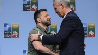 NATO Secretary General Jens Stoltenberg (R) shakes hands with Ukrainian President Volodymyr Zelensky after a joint press conference on the sidelines of the NATO Summit in Vilnius on July 12, 2023.