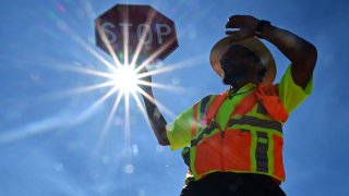 Traffic warden Rai Rogers mans his street corner during an 8-hour shift under the hot sun in Las Vegas, Nevada on July 12, 2023, where temperatures reached 106 degrees amid an ongoing heatwave. More than 50 million Americans are set to bake under dangerously high temperatures this week, from California to Texas to Florida, as a heat wave builds across the southern United States.