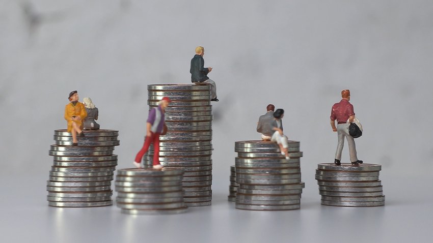 Plastic figures sitting on coins.