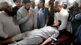 People transport an injured victim of a powerful bomb upon arrival at a hospital in Peshawar, Pakistan, Sunday, July 30, 2023. A bomb ripped through a rally by supporters of a hard-line cleric and political leader in the country’s northwestern Bajur district that borders Afghanistan on Sunday, police and health officials said.