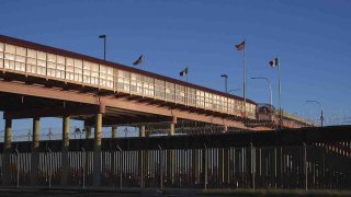 FILE - Migrants line up to be processed by U.S. Border Patrol under the Stanton St. Bridge in El Paso, Texas, on Dec. 21, 2022.