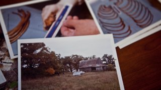 File - On Sept. 11, 2010, Scott McCord, the coroner of Newton County Indiana, shows photos of the crime scene where four bodies were found in 1983 and believed to be victims of serial killer Larry Eyler.